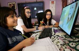 People around the world are turning to technology to stay connected during lockdowns, including connecting with friends and learning online. By YASSER AL-ZAYYAT (AFP/File)
