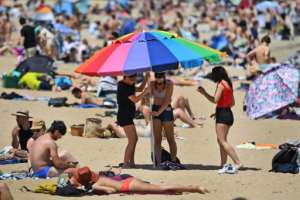 People enjoy the warm weather on Melbourne's St Kilda Beach after the Australian city began to lift virus restrictions. By William WEST (AFP/File)