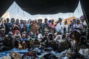 People fleeing violence in the Metekel zone gather outside a tent where clothes are being distributed at a camp in Chagni, Ethiopia. By EDUARDO SOTERAS (AFP)