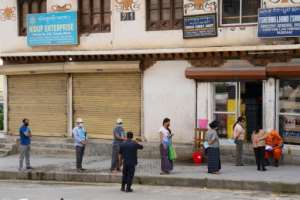 People in masks maintain social distancing as they queue to buy groceries in Thimphu, Bhutan. The Himalayan kingdom says it will only start vaccinating citizens on an