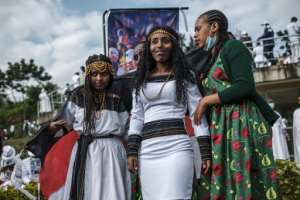 People in traditional clothing pose for pictures during the Oromo people's thanksgiving holiday, in Addis Ababa. It comes against a backdrop of unrest and political division.. By EDUARDO SOTERAS (AFP)