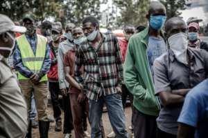 People queue while waiting their turn to be tested for COVID-19 in the Kawangware slums of Nairobi, Kenya. By LUIS TATO (AFP)