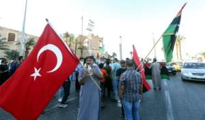 People wave flags of Libya (R) and Turkey (L) during a demonstration in Tripoli. By Mahmud TURKIA (AFP)
