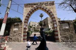 People walk past Qasr al-Basha, where Napoleon Bonaparte reportedly stayed, in Gaza City on April 21, 2021. By Emmanuel DUNAND (AFP)
