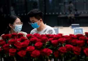 People wearing protective face masks in Shenzhen, China, on May 19, 2020. Chinese officials have accused US President Donald Trump of trying to damage the World Health Organization for political ends. By NOEL CELIS (AFP)