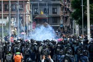 People throw stones during clashes with the police after authorities tried to halt the annual Buddhist chariot procession of Rato Machindranath amid restrictions to prevent the spread of the Covid-19 coronavirus in Lalitpur, Nepal. By PRAKASH MATHEMA (AFP)