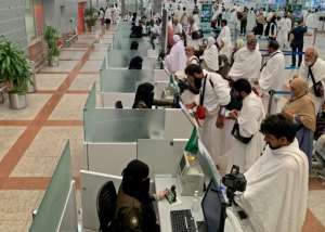 Pilgrims, shown in the Saudi media ministry photo, go through passport control before travelling to Mecca, Islam's holiest city. By - (AFP)