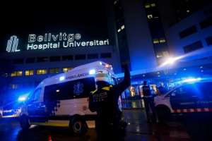 Police and other security forces gather outside the Bellvitge hospital near Barcelona to applaud and cheer healthcare workers. By Pau Barrena (AFP)