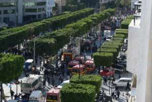 Police and firemen gather at the site of a suicide attack in the centre of the Tunisian capital Tunis after a woman blew herself up killing nine people.  By FETHI BELAID (AFP)