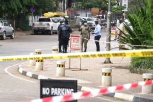 Police officers secure the site of one of the bombings near the Ugandan parliament. By Sumy SADRUNI (AFP/File)