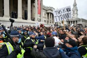Police move in on lockdown protesters in London's Trafalgar Square. By JUSTIN TALLIS (AFP)