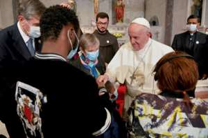 Pope Francis meets with migrants at the Church of the Holy Cross near the United Nations buffer zone in Nicosia. By - (VATICAN MEDIA/AFP)
