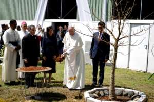 Pope Francis planted a baobab tree with Madagascar President Andry Rajoelina at the presidential palace in Antananarivo. By MARCO LONGARI (AFP)