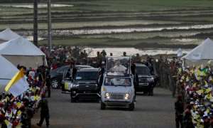 Pope Francis waved to the crowds as he arrived for a vigil with young people in Antananarivo. By Tiziana FABI (AFP)