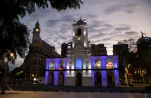 Portraits of essential workers are projected on the facade of the Cabildo of Buenos Aires. Latin America is the worst-hit region and is still struggling with its first wave of coronavirus infections. By ALEJANDRO PAGNI (AFP)