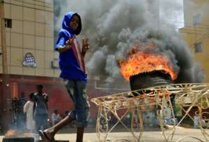 Plumes of smoke from burning tyres set ablaze by demonstrators rose over Khartoum. By Ebrahim Hamid (AFP)