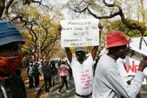 Protesters at the Zimbabwean embassy in South Africa. By Phill Magakoe (AFP)