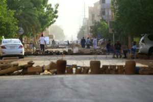 Protesters block a main street in the Sudanese capital Khartoum to stop military vehicles from driving through the area on June 4, 2019 after a crackdown on protesters that killed dozens. By - (AFP)