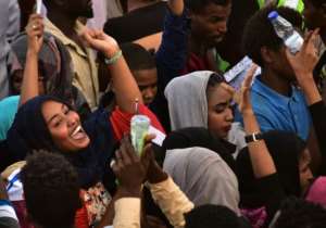 Protesters celebrate concessions made by Sudan's new military council on Saturday. By AHMED MUSTAFA (AFP)