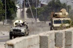 The pro-GNA fighters use armored vehicles, vans and civilian cars to transport men and weapons to the front. By Mahmud TURKIA (AFP)