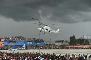 President Alassane Ouattara used a helicopter to make a dramatic appearance at his final rally on Thursday. By SIA KAMBOU (AFP)