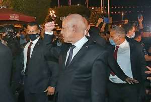 President Saied gestures in Tunis's central Habib Bourguiba Avenue after he ousted the premier and ordered parliament closed. By - (Tunisian presidency Facebook page/AFP)