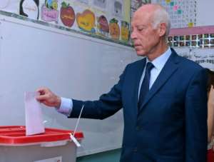 Presidential candidate Kais Saied casts his ballot at a polling station in Tunis. By HASNA (AFP)