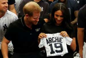 Prince Harry and Meghan were presented with gifts for Archie when they met New York Yankees players earlier this year. By PETER NICHOLLS (POOL/AFP/File)