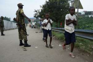 Pupils from Congolese villages must sometimes rush through the Mponwe border point with Uganda, trying to get to school on time despite lengthy Ebola health checks. By ISAAC KASAMANI (AFP/File)