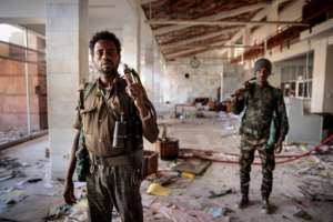 Ransacked: Amhara Fano militia fighters walk in the terminal at Lalibela airport on Tuesday. By Solan KOLLI (AFP)