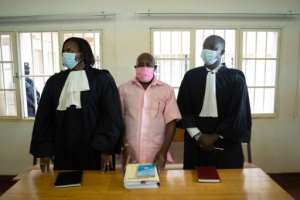 Rusesabagina, centre, seen in prison uniform at his court appearance in Kigali last October. By Simon Wohlfahrt (AFP)