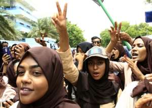 Scores of students of a Khartoum university celebrate after an agreement is reached between protest leaders and the transitional military council. By Ebrahim HAMID (AFP)