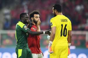 Sadio Mane and Mohamed Salah with Egypt goalkeeper Mohamed Abou Gabal.  By CHARLY TRIBALLEAU (AFP)