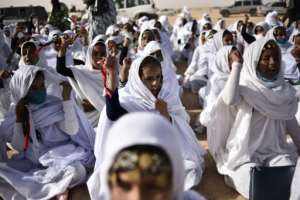 Young Sahrawi girls in traditional dress attend celebrations marking the 45th anniversary of the declaration of the Sahrawi Arab Democratic Republic, in a refugee camp on the outskirts of the Algerian town of Tindouf.  By RYAD KRAMDI (AFP)