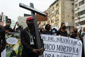 Several hundred demonstrators marched in Angola's capital over the death of a doctor detained by police for not wearing a mask. By Osvaldo Silva (AFP)