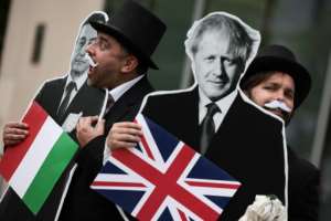 Show us the money: Protestors posing as debt collectors with cardboard cutouts of Italian Prime Minister Mario Draghi and British Prime Boris Johnson outside the International Monetary Fund (IMF) this month. By Anna Moneymaker (GETTY IMAGES NORTH AMERICA/AFP)