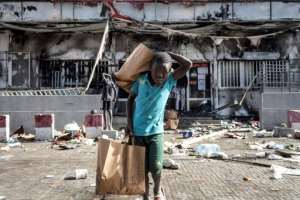 Shops were set on fire and looted in the unrest.  By JOHN WESSELS (AFP)