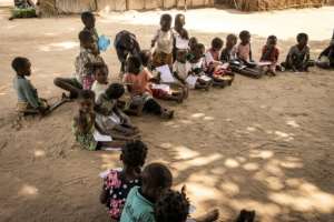 Some drew military helicopters, while others sketched the makeshift structures that have become their new homes, built from bamboo reeds and mud at the dusty camp. By JOHN WESSELS (AFP)
