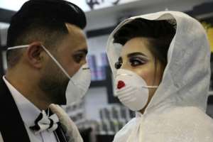 Some people are making creative use of their masks, such as at this Palestinian wedding. By HAZEM BADER (AFP)