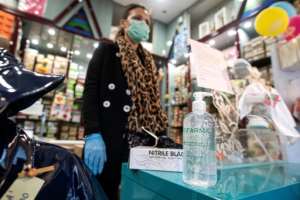 Some shops cautiously reopened in Italy, with clerks wearing face masks and gloves and offering hand sanitiser. By Tiziana FABI (AFP)