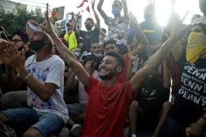 Some Tunisians celebrated the president's move, cheering outside the army-barricaded parliament. By YASSINE MAHJOUB (AFP)