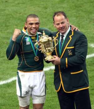 South Africa's coach Jake White wing Bryan Habana celebrate with the cup. By FRANCK FIFE (AFP)