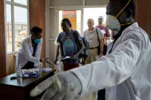 South Sudan has ordered a nightly lockdown. Here, passengers from an international flight are given a temperature screening at Juba airport. By Alex McBride (AFP/File)