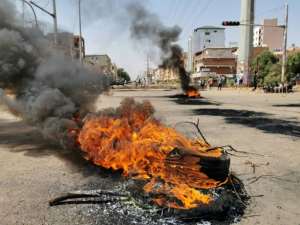 Smoke billows from burning tyres in Khartoum during a protest against the coup -- repression of protests could reignite the country's civil wars, an analyst said. By - (AFP)