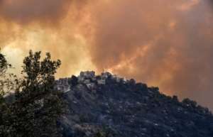 Smoke rises from a wildfire in the forested hills of the Kabylie region, east of the capital Algiers. By Ryad KRAMDI (AFP)