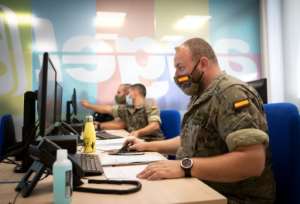 Spanish soldiers work at a coronavirus patient tracking centre in Palma de Mallorca. By JAIME REINA (AFP)