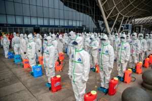 Staff prepare to spray disinfectant at Wuhan Railway Station. By STR (AFP)