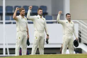 Standing not kneeling: South Africa's Wiaan Mulder, Aiden Markram and Dean Elgar raise their fists before the first Test against the West Indies in St Lucia in June. By Randy Brooks (AFP/File)