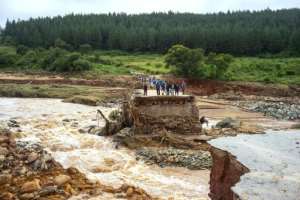 Stranded: Loggers on a damaged road on Charter Estate, Chimanimani. By Zinyange AUNTONY (AFP)