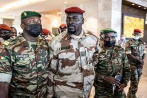 Strongman: Junta leader Colonel Mamady Doumbouya, centre. By JOHN WESSELS (AFP)